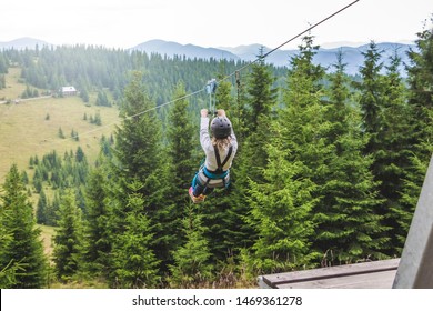 Descent From The Mountain On A Metal Cable. Zipline Is An Extreme Kind Of Fun In Nature