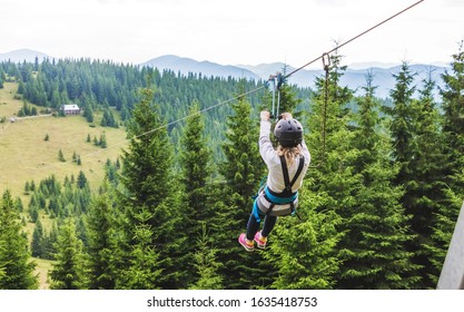 Descent From The Mountain On A Metal Cable. Zipline Is An Extreme Kind Of Fun In Nature