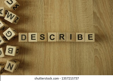 Describe word from wooden blocks on desk - Shutterstock ID 1357215737