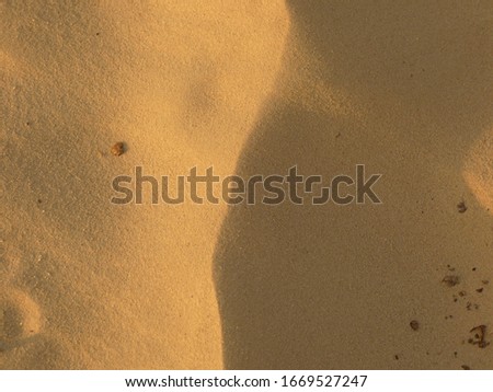 
desert dune from above with shadows from one side and sun on the other