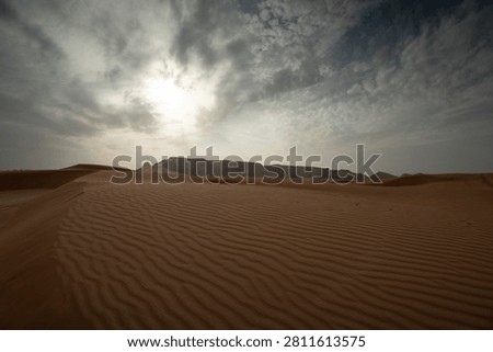 Desert Dunes Under Dramatic Cloudy Sky