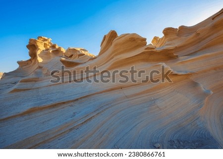 Desert eroded rock pattern with clear sky. Desert rock formation with erosion