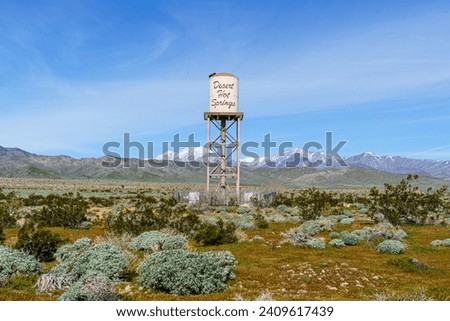 Desert Hot Springs, California water tower centered in frame with snow capped San Gorgonio Mountains in the background