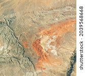 Desert land on satellite picture, aerial top view of terrain, physical map as abstract texture background. Theme of nature pattern, photo and topography. Elements of this image furnished by NASA. 