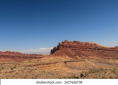 Desert Landscape Of Brown And Yellow Slanted Stone Hillside At The San Rafael Swell Along Interstate 70 In Utah