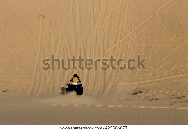 the desert and play atv\
bike