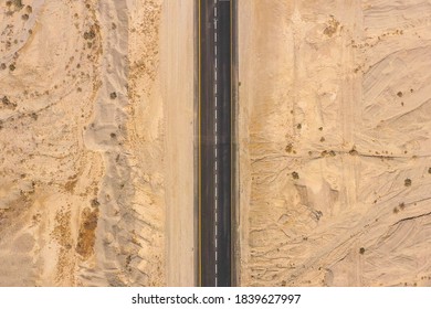 Desert road, Aerial image of a two lane road surrounded by dry desert landscape