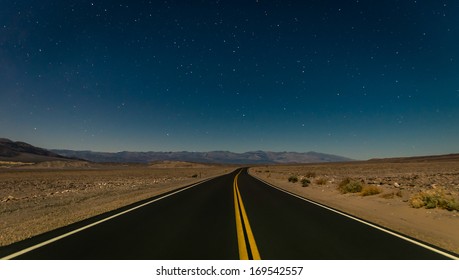 Desert road in the Death Valley by night - Powered by Shutterstock