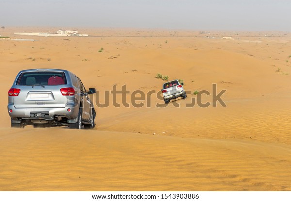 Desert Safari by car bashing through\
the arabian sand dunes. Dubai, UAE, United Arab\
Emirates