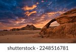 A desert scene with a rock bridge in Wadi Rum, Jordan.