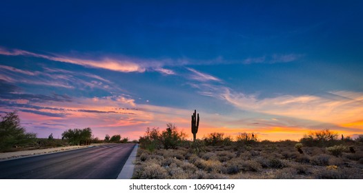 A Desert Sunset In Scottsdale, Arizona Highlighted By A Road Leading To Infinity.