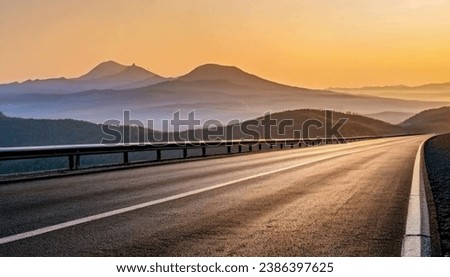 Deserted asphalt road and mountain landscape at dawn