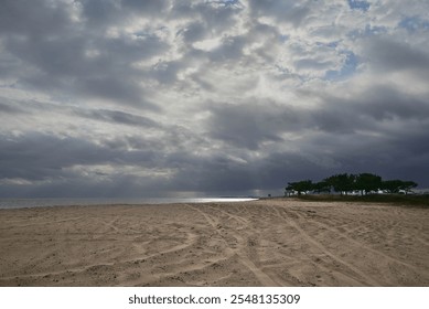 Deserted beach and cloudy grey sky on the horizon - Powered by Shutterstock