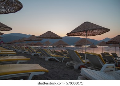 Deserted Beach In The Morning Sun. The Beach At Dawn. Empty Sunbeds. Beach Without People. Marmaris, Turkey.