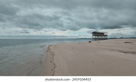 A Deserted Beach and Stilt House - Powered by Shutterstock