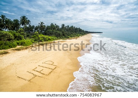 Deserted beach of uninhabited tropical island, sand with inscription HELP, lost in sea calls for help. Aerial view of empty ocean island shore with palms. Shipwreck, sos, island and castaway theme.