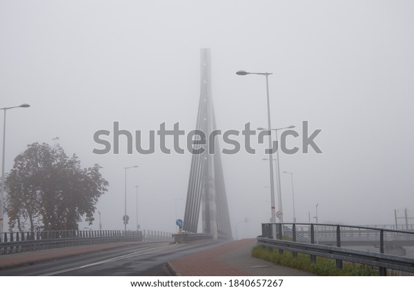 deserted car viaduct in thick morning autumn fog.\
selected focus 