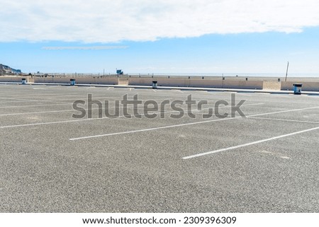 Deserted parking lot along a sandy beach on the coast of California on a sunny autumn morning