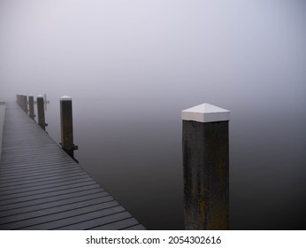 Deserted Pier with bollards in the fog, Noord aa, Zoetermeer, Netherlands