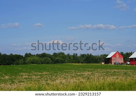 Deserted Red barn on an open uncultivated land. 