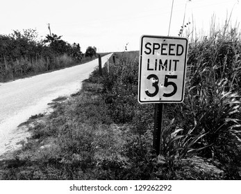 Deserted road with a low speed limit sign. - Powered by Shutterstock