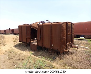 A deserted rusted wagon at a yard ground 