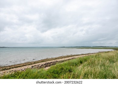 Deserted Rustic Beach On A Stormy Summer Day