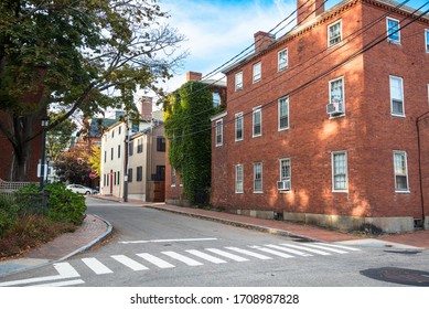Deserted street lined with brick and wooden buildings in a downtown on a clear autumn day - Powered by Shutterstock
