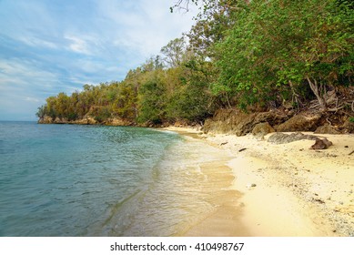 Deserted tropical beach on Bolilanga Island. Togean Islands or Togian  in the Gulf of Tomini. Central Sulawesi. Indonesia