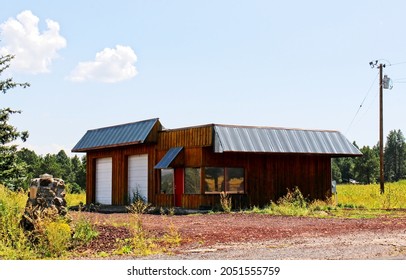 Deserted Wooden Building With Two Roll Up Garage Doors