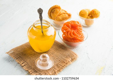 Desi Ghee With Indian Sweets Like Gujiya, Motichoor Laddu And Imarti Or Jalebi