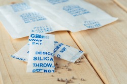 Desiccant Or Silica Gel Sachets On The Wooden Background