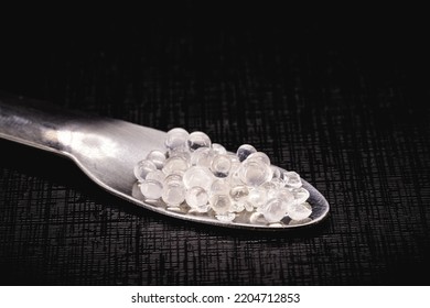 Desiccant or silica gel in white paper packaging and spread on isolated black background, anti mildew gel - Shutterstock ID 2204712853