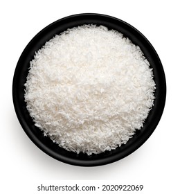 Desiccated Coconut In Black Ceramic Bowl Isolated On White. Top View.