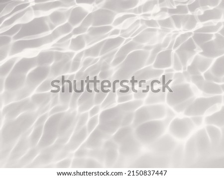 Closeup​ abstract​ of​ surface​ water​ for​ graphic​ design. Reflection​ of​ sunlight​ to​ surface​ blue​ water​ for​ background. Water​ splashed​ for​ background. Water​ pattern​ for​ background.