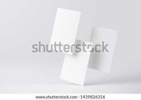 Design concept - front view of three surreal white business card float on mid air isolated on white background for mockup, it's real photo, not 3D render