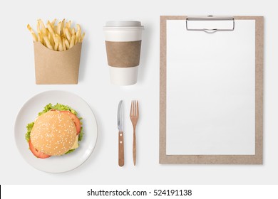 Design Concept Of Mockup Burger, French Fries, Coffee Cup And Clip Board Set Isolated On White Background. Copyspace For Text And Logo. Clipping Path Included On White Background.