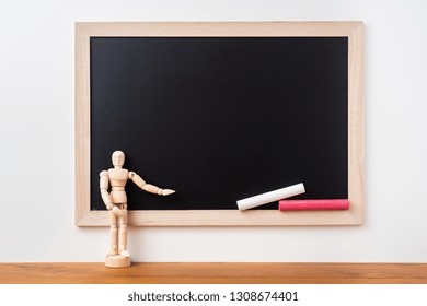 Design concept - Perspective view of blackboard and wood doll on white background  with teak floor for mockup - Powered by Shutterstock