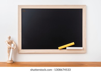 Design concept - Perspective view of blackboard and wood doll on white background  with teak floor for mockup - Powered by Shutterstock