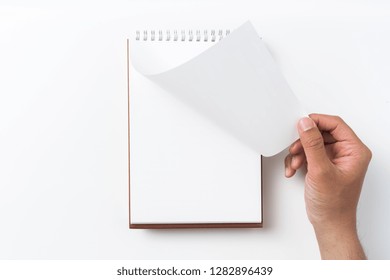 Design Concept - Perspective View Brown Hardcover Spiral Notebook, Man's Hand Flip Curl Page Isolated On Background For Mockup