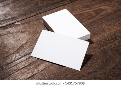 Design Concept - Perspective View Of White Business Card On Wood Floor Background For Mockup