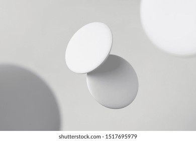 Design Concept - Top View Of 2 White Badge Float On White Background With Blur Effect For Mockup, It's Real Photo, Not 3D Render