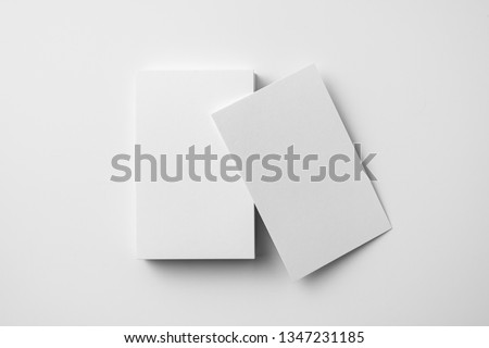 Design concept - top view of 2 vertical business card isolated on white background for mockup, it's real photo, not 3D render