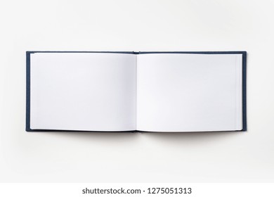 Design Concept - Top View Blue Hardcover Notebook With Open & Flip Curl Rolled Page Isolated On Background For Mockup