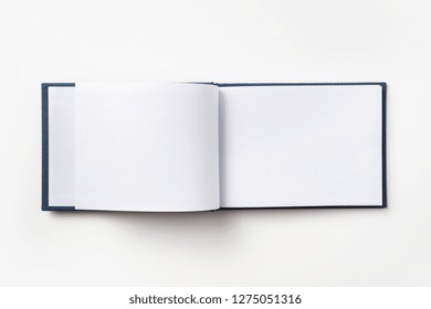 Design Concept - Top View Blue Hardcover Notebook With Open & Flip Curl Rolled Page Isolated On Background For Mockup