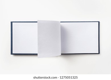 Design Concept - Top View Blue Hardcover Notebook With Open & Flip Curl Rolled Page Isolated On Background For Mockup