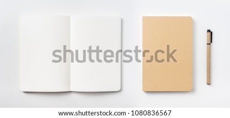 Design concept - Top view of hardcover kraft notebook and ballpoint pen isolated on white background for mockup