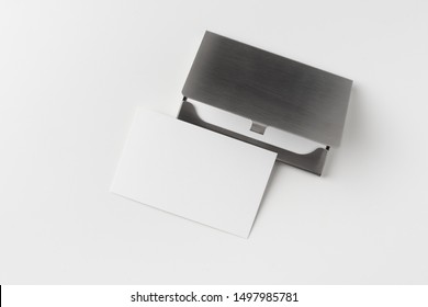 Design concept - top view of horizontal business card with stainless steel case isolated on white background for mockup, it's real photo, not 3D render