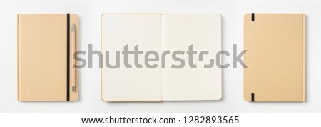 Design concept - Top view of kraft paper notebook, white page and pencil isolated on background for mockup