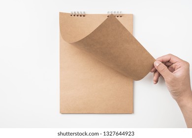 Design Concept - Top View Of Man's Hand Turn Up Kraft Page Isolated On White Background For Mockup